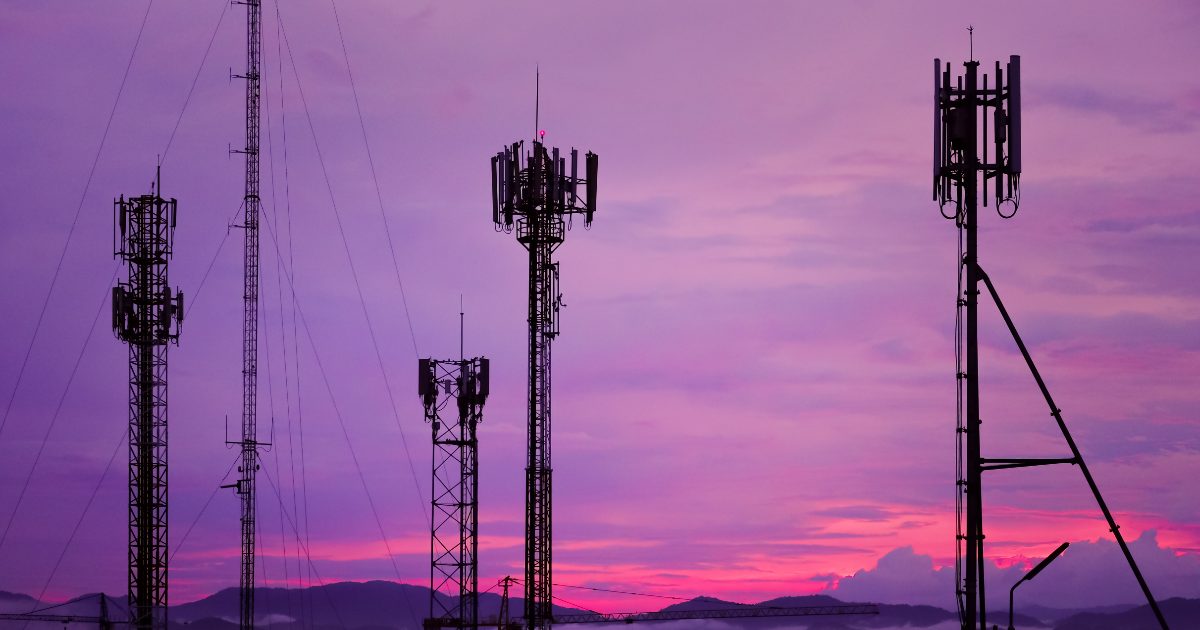 cell towers on a purple sky