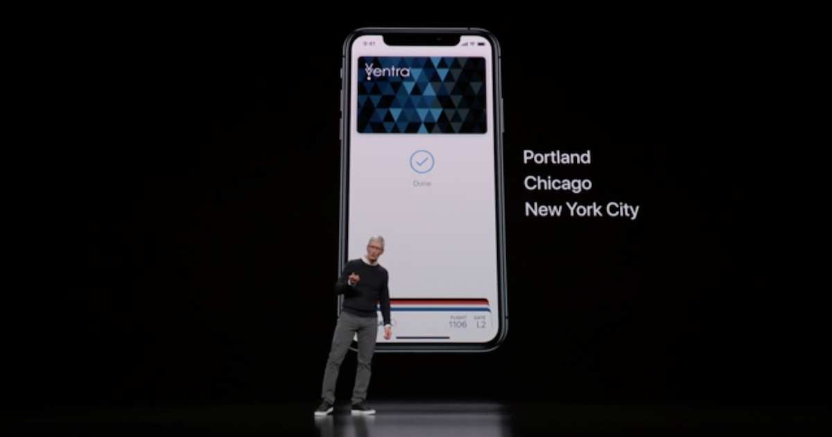 Tim Cook on stage in front of a slide displaying an iPhone with a transit card in the Wallet app