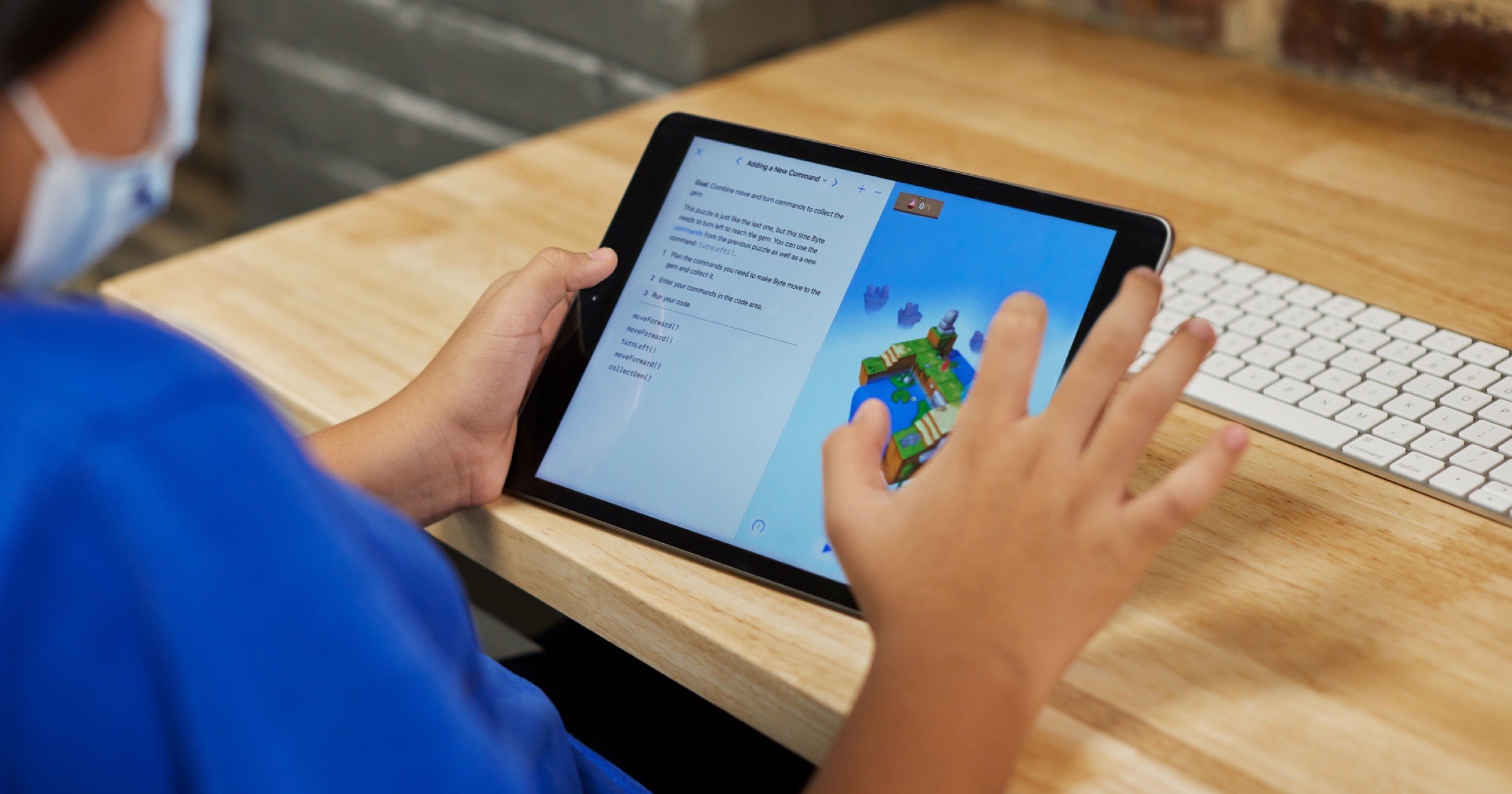 Kid using an iPad to play with Apple’s swift playgrounds app.