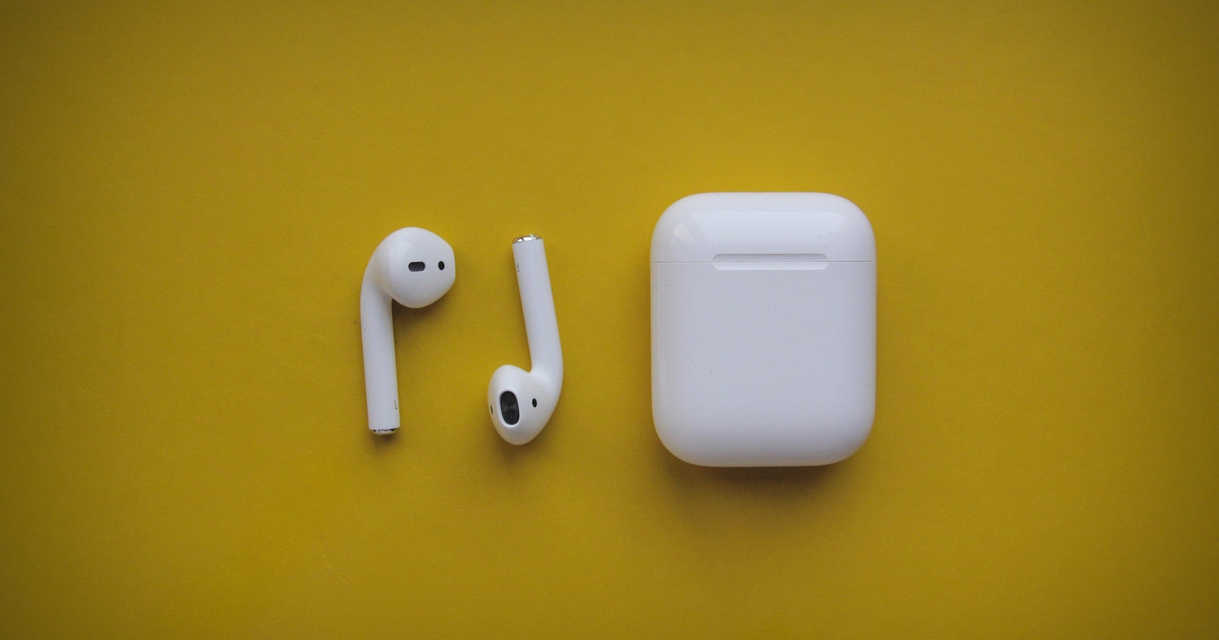 airpods on yellow background