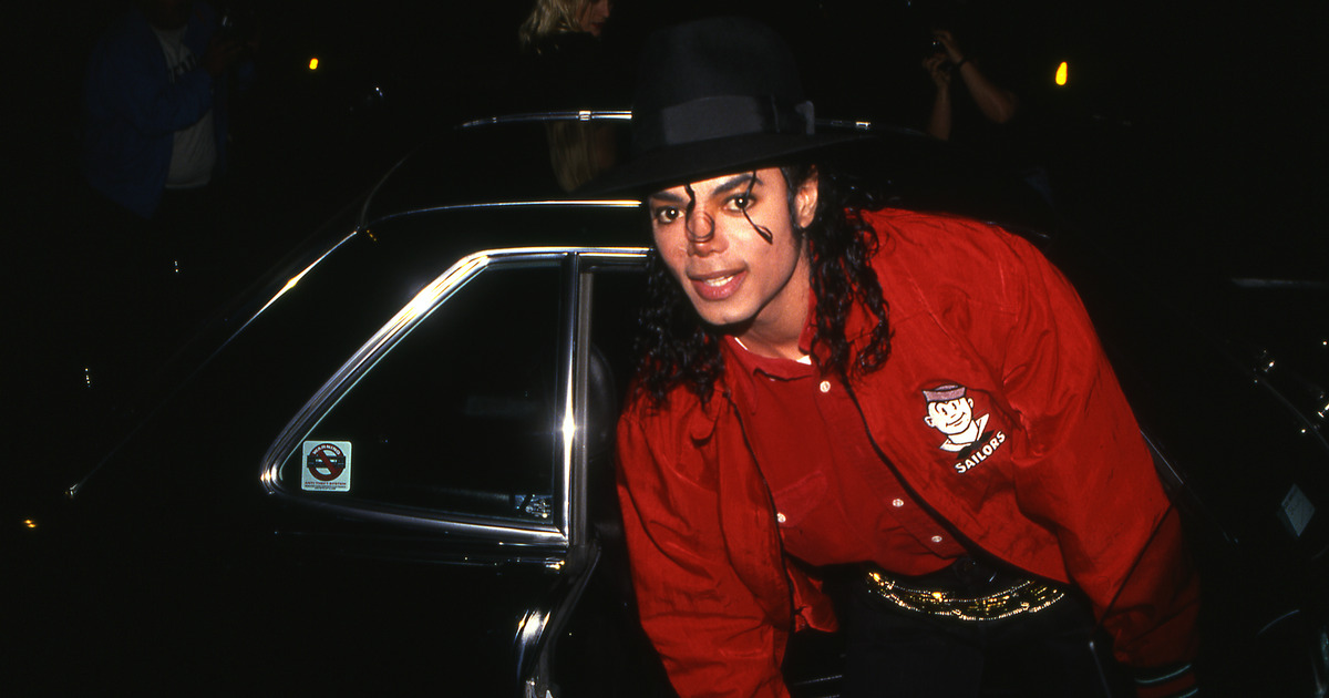 Michael Jackson in front of a black car